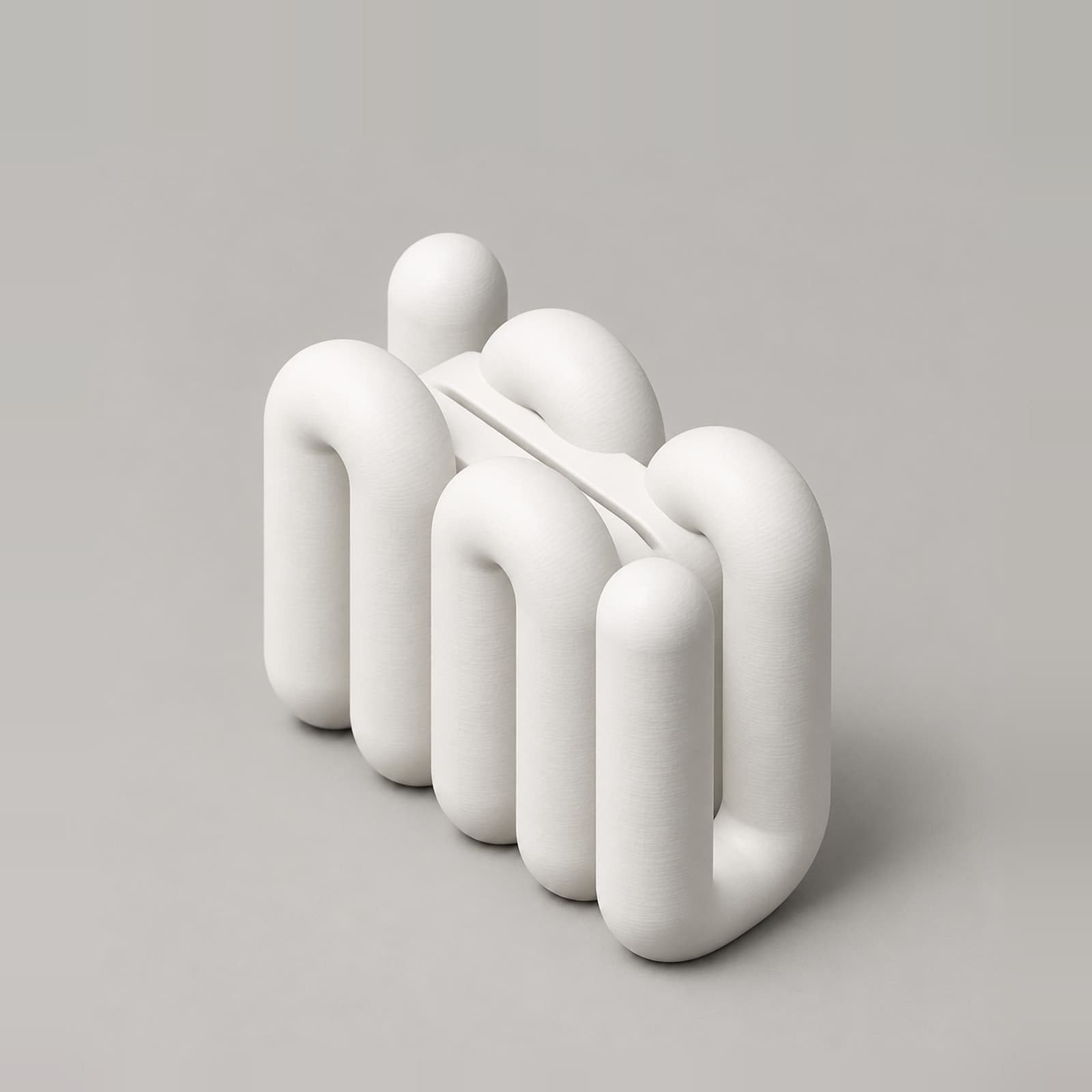 Portico – kleiner Fotohalter aus verschlungenen Rundrohr-Schlaufen aus dem 3D-Druck
